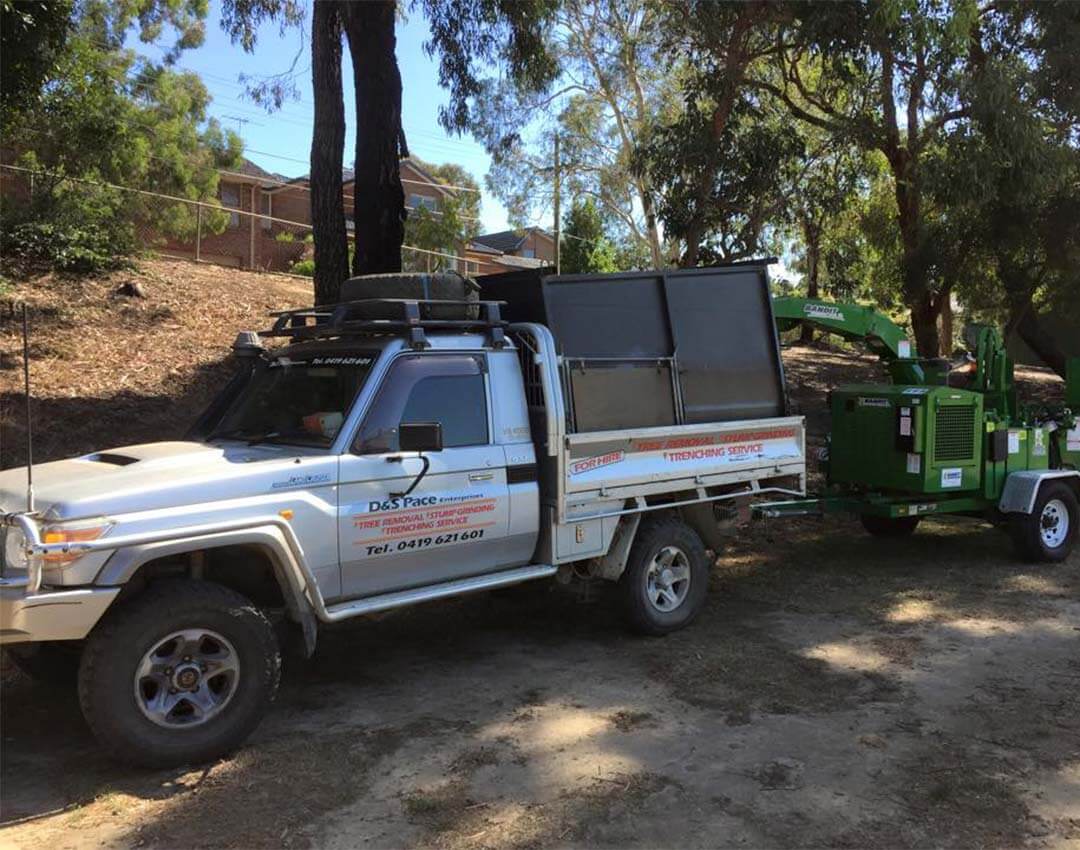 The Ranges Tree Service ute, attached to a chipper in the Yarra Valley.